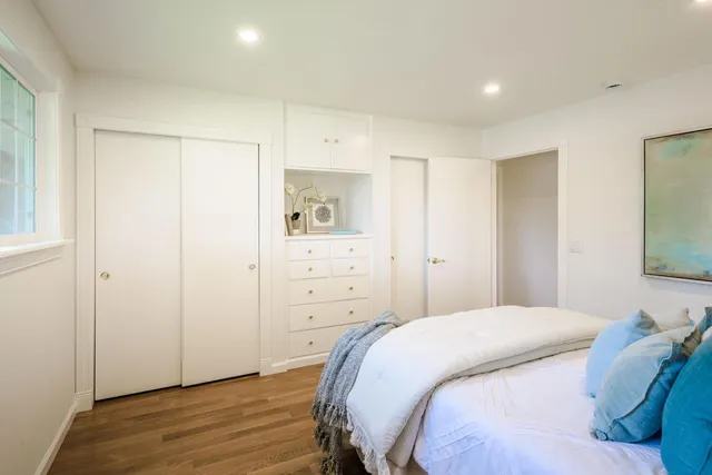 a bedroom with a bed and a mirror