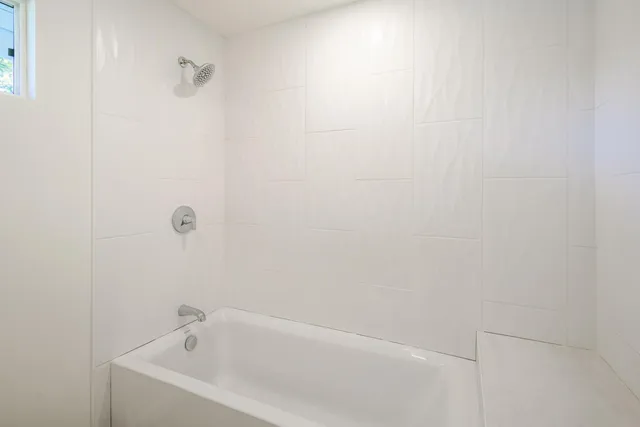 a white bath tub sitting in a bathroom
