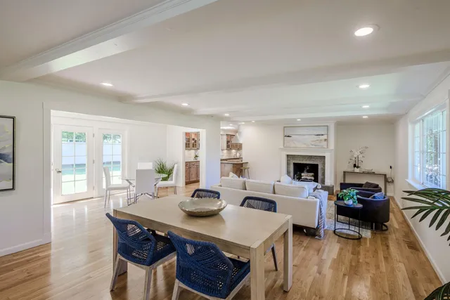 a living room with furniture a fireplace and a table