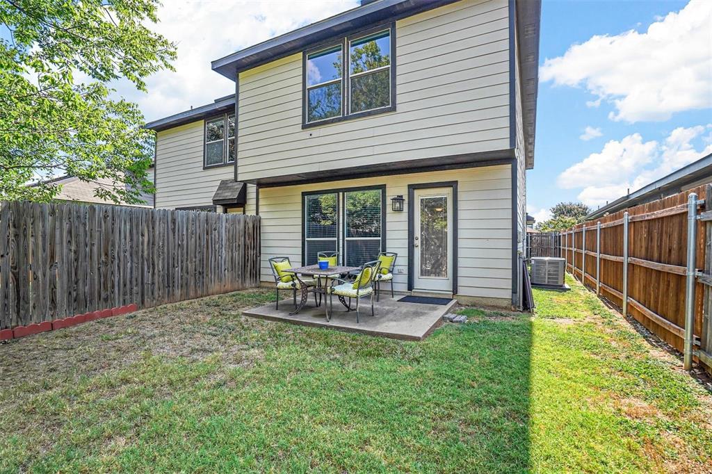 5113 Mountain Spring Trail Fort Worth, TX 76123 - Photo 33 of 35 a view of backyard with table and chairs and wooden fence