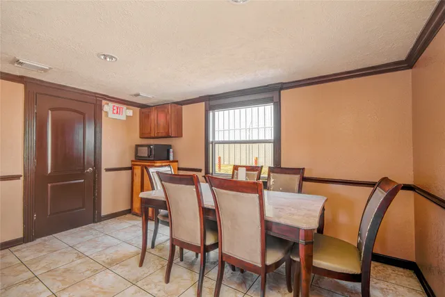 a view of a dining room with furniture and a window