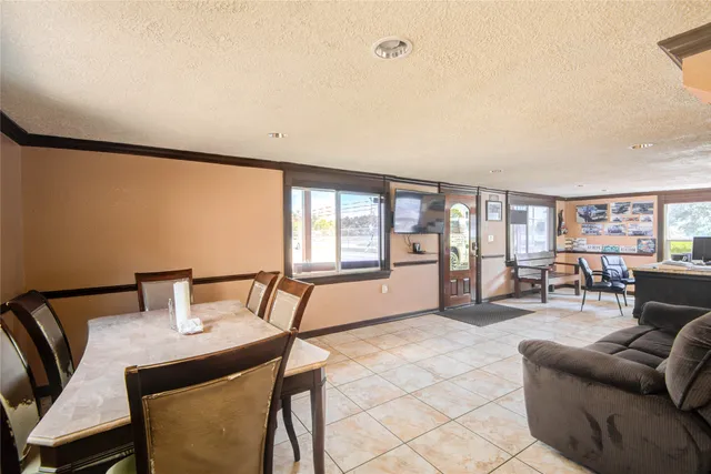 a living room with furniture a flat screen tv and a large window