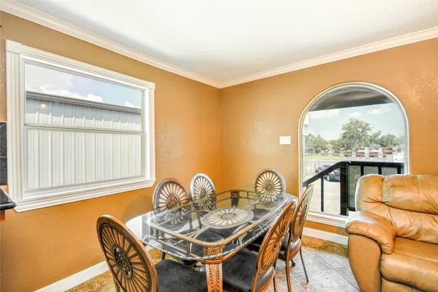 a view of a dining room with furniture window and outside view