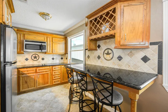 a kitchen with stainless steel appliances granite countertop a sink and a cabinets