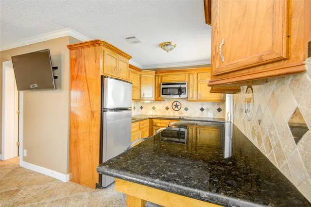 a kitchen with stainless steel appliances granite countertop a sink and cabinets