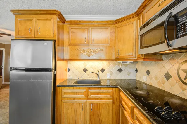 a kitchen with a refrigerator and a stove