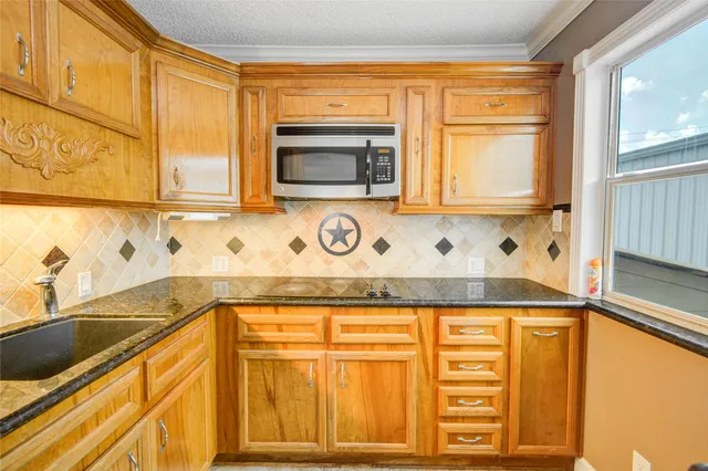 a view of a kitchen with a sink and windows
