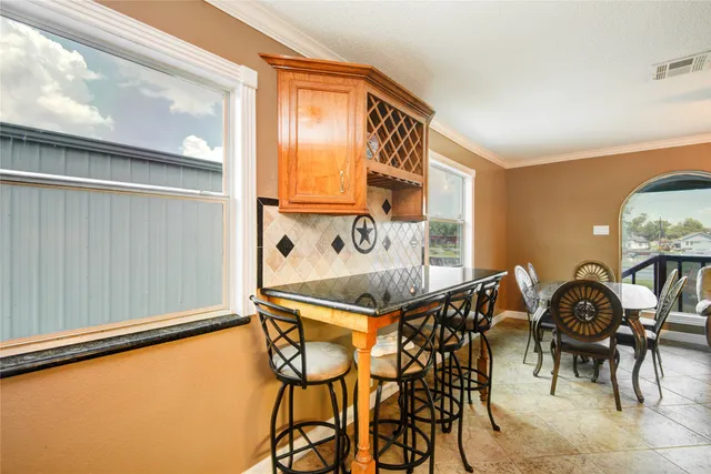 a table and chairs in a room with window