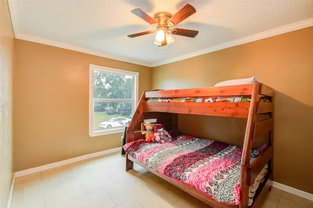 a bed sitting in a bedroom next to a window