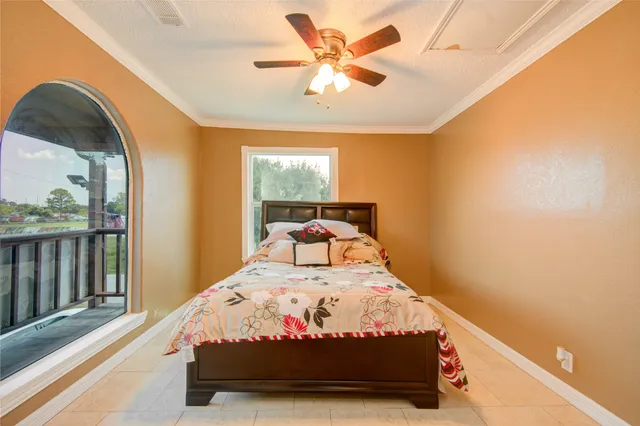 a bed sitting in a bedroom next to a window