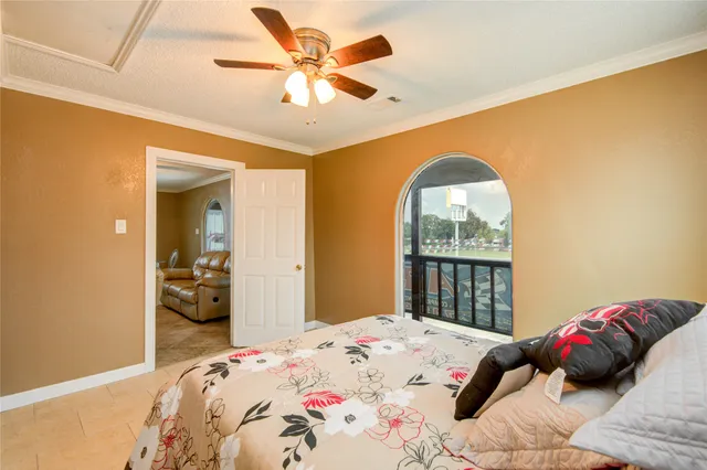 a bedroom with a large bed and a window