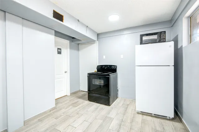 a kitchen with a refrigerator and a stove