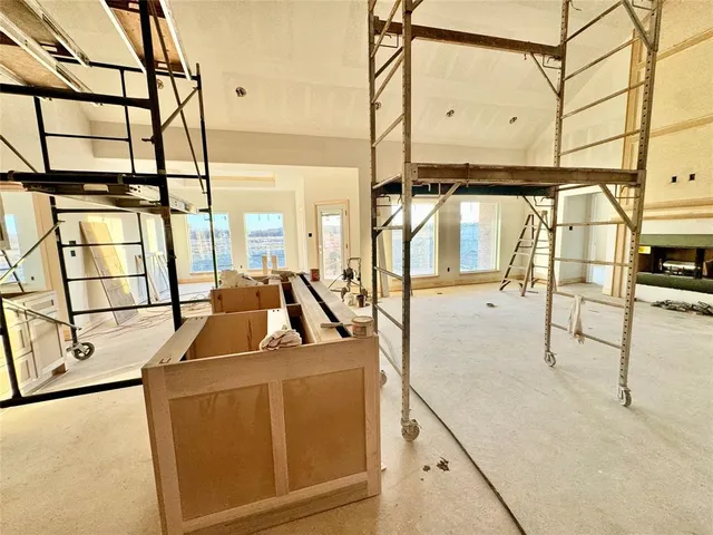 a room with lots of wooden furniture and a chandelier