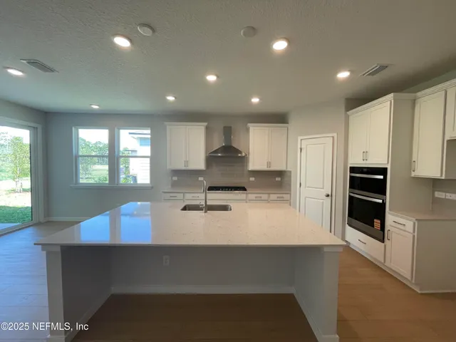 a kitchen with white cabinets and white appliances