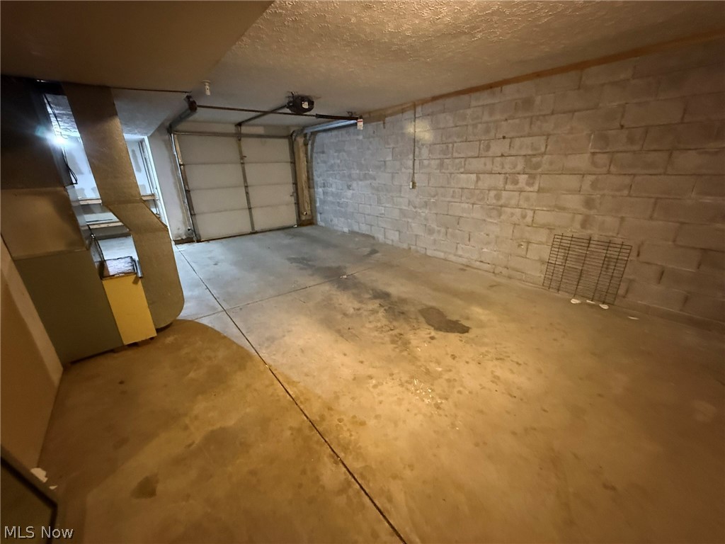 604 Harger Street Dover, OH 44622 - Photo 18 of 25 Garage with concrete block wall and a garage door opener