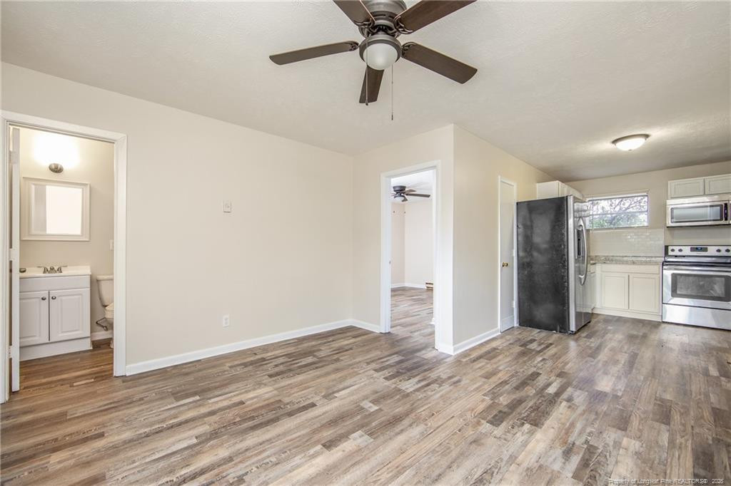 4305 Rosehill Road, Unit D D Fayetteville, NC 28311 - Photo 2 of 10 a view of a kitchen with wooden floor and a ceiling fan
