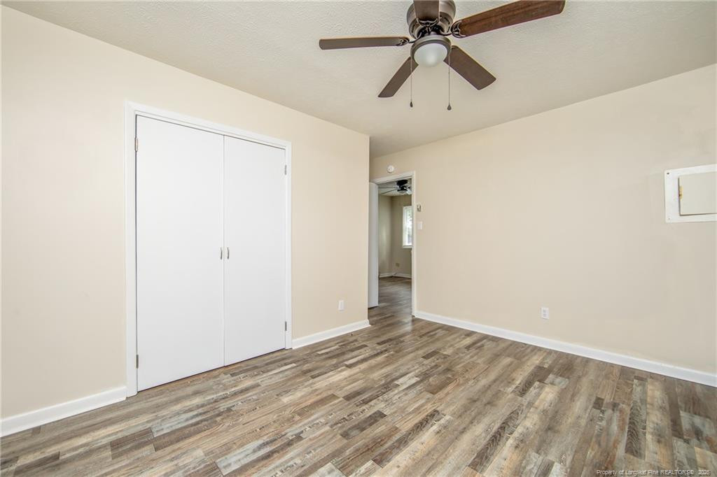 4305 Rosehill Road, Unit D D Fayetteville, NC 28311 - Photo 4 of 10 a view of a room with wooden floor and ceiling fan