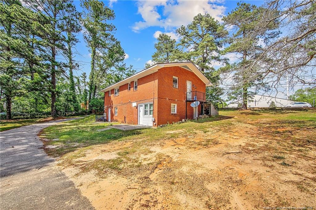 4305 Rosehill Road, Unit D D Fayetteville, NC 28311 - Photo 7 of 10 a view of a wooden house with a yard