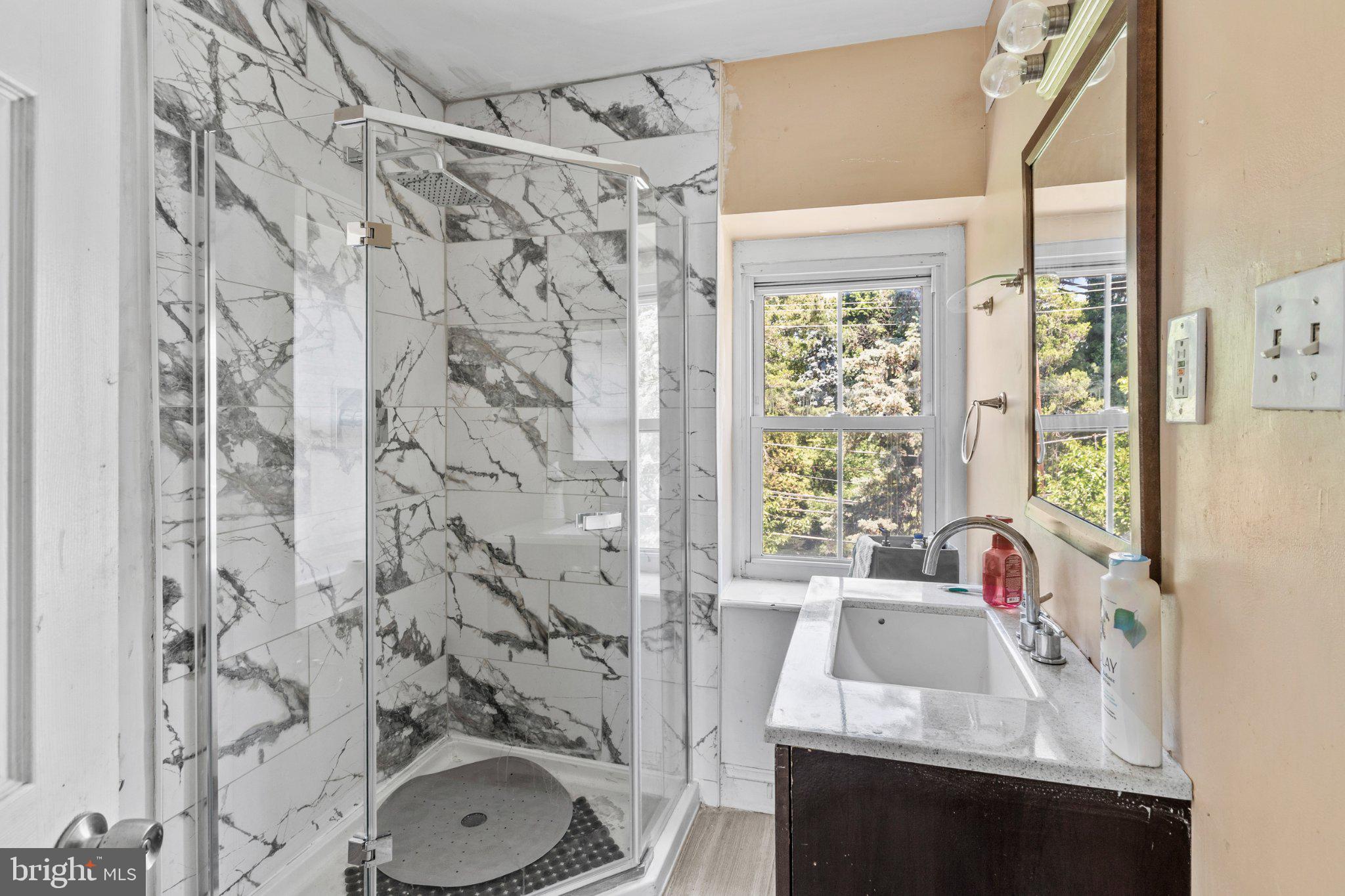 242 Church Road Elkins Park, PA 19027 - Photo 24 of 29 Elegant marble shower with natural light.