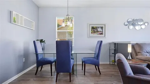 a view of a dining room with furniture and chandelier