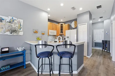 a kitchen with a stove a sink and a refrigerator