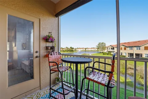 a view of a chairs and table in the balcony
