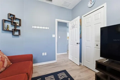 a bedroom with a bed and flat screen tv