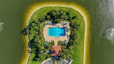 an aerial view of residential houses with outdoor space and trees