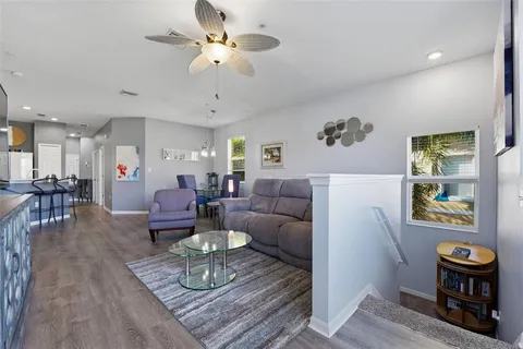 a living room with furniture a dining table and a chandelier