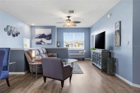a living room with furniture and a wooden floor