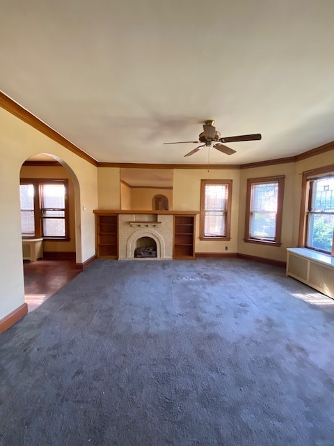 3019 North Kenneth Avenue Chicago, IL 60641 - Photo 4 of 21 an empty room with fireplace and windows