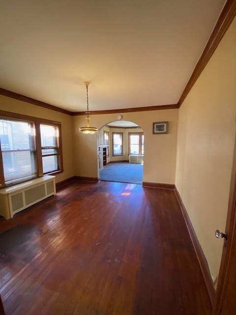 3019 North Kenneth Avenue Chicago, IL 60641 - Photo 8 of 21 an empty room with wooden floor and windows