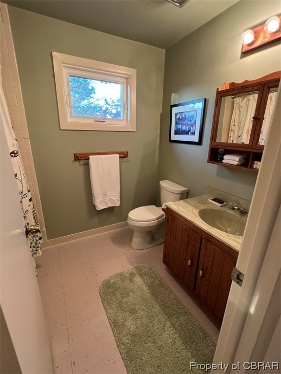 790 Long Point Lane Topping, VA 23169 - Photo 9 of 26 Bathroom featuring tile floors, toilet, and vanity