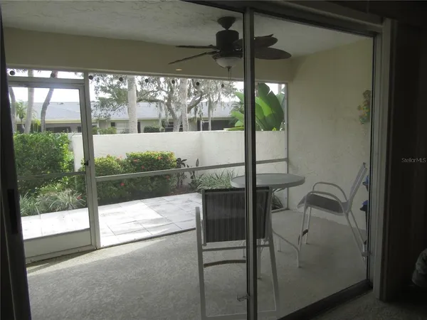 a porch with a glass door and shower