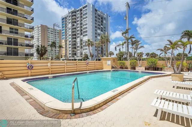 a view of a swimming pool with a lounge chairs