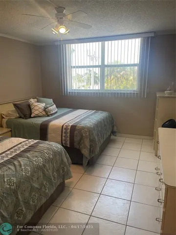 a bathroom with a granite countertop sink a toilet a mirror and shower