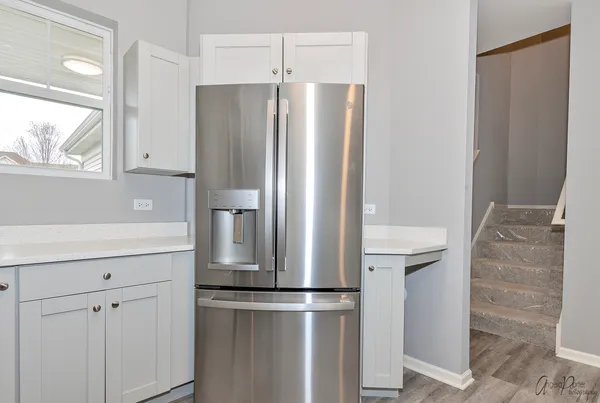 a kitchen with stainless steel appliances a refrigerator and cabinets