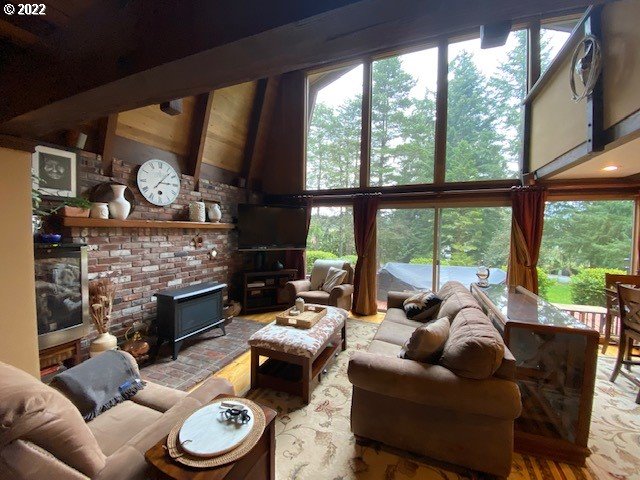 41945 Southeast Dover Court Sandy, OR 97055 - Photo 2 of 32 a living room with furniture a fireplace a large window and a flat tv screen