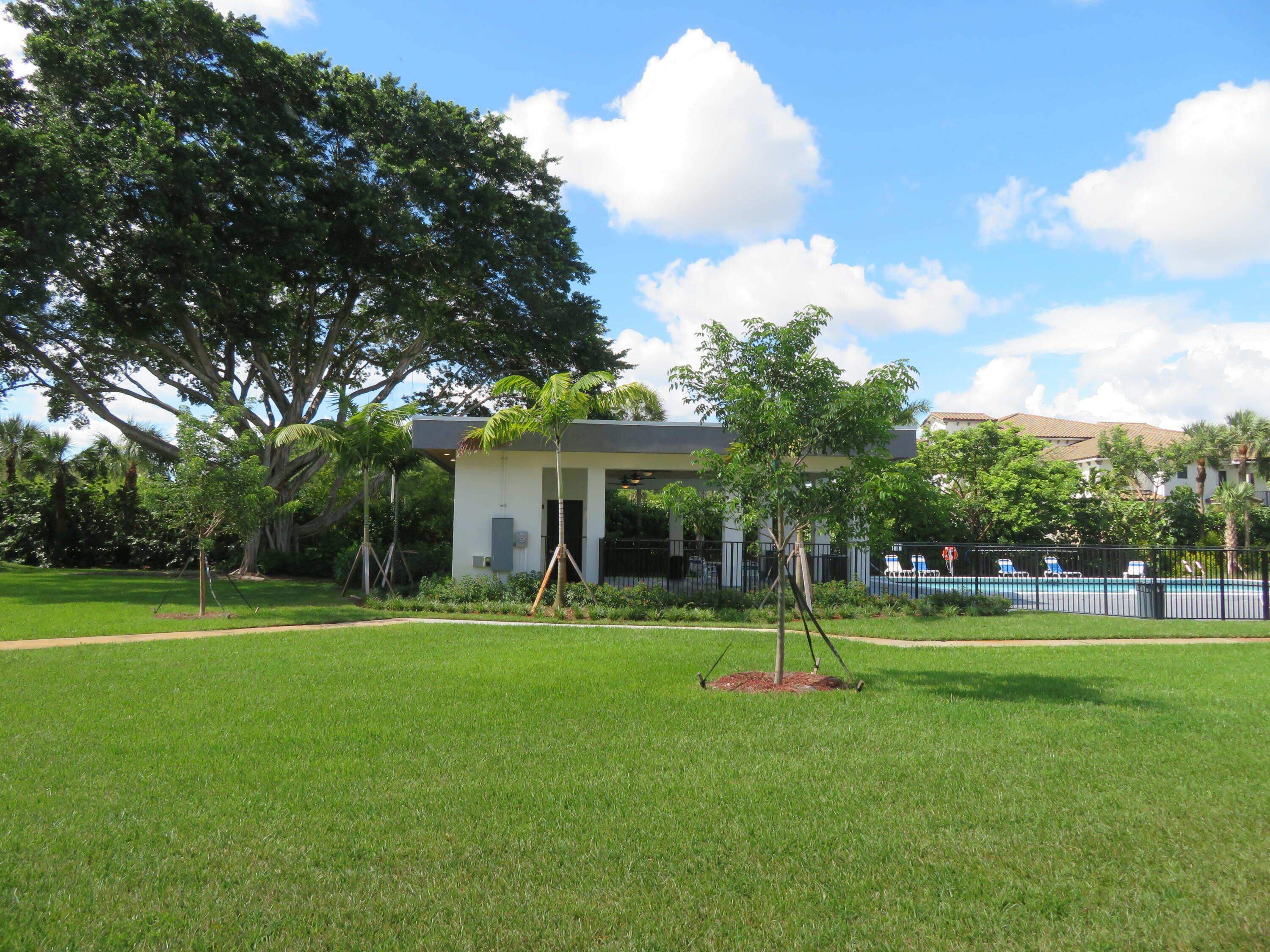 9233 Southwest 8th Street, Unit 119 Boca Raton, FL 33428 - Photo 21 of 42 a front view of a house with a yard