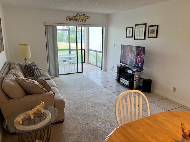 9233 Southwest 8th Street, Unit 119 Boca Raton, FL 33428 - Photo 29 of 42 a living room with furniture and a window