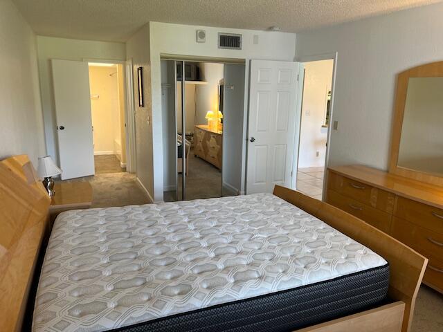 9233 Southwest 8th Street, Unit 119 Boca Raton, FL 33428 - Photo 33 of 42 a bedroom with a bed and wooden floor
