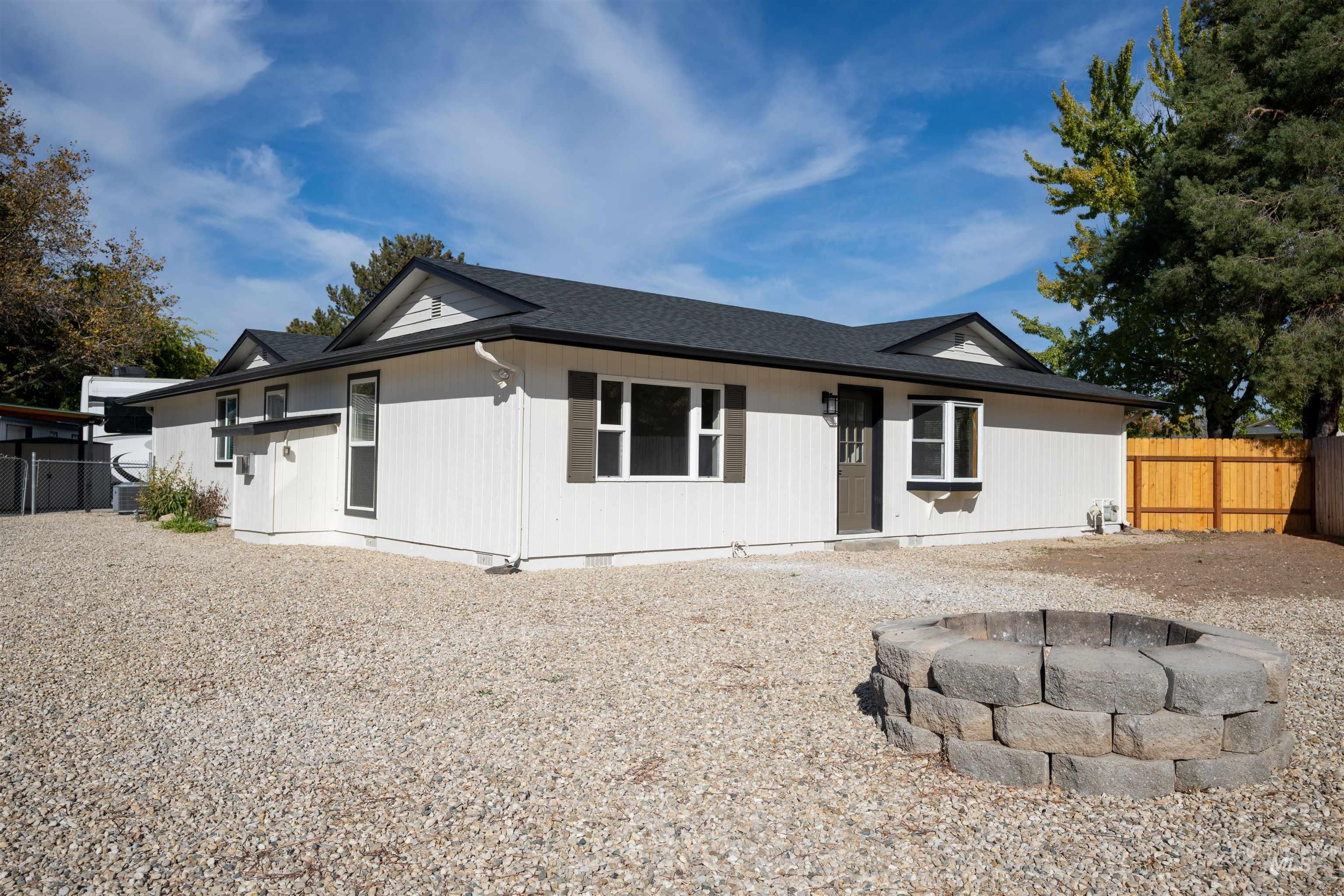4667 Shawnee Way Boise, ID 83709 - Photo 7 of 24 View of front facade with an outdoor fire pit, roof with shingles, and crawl space
