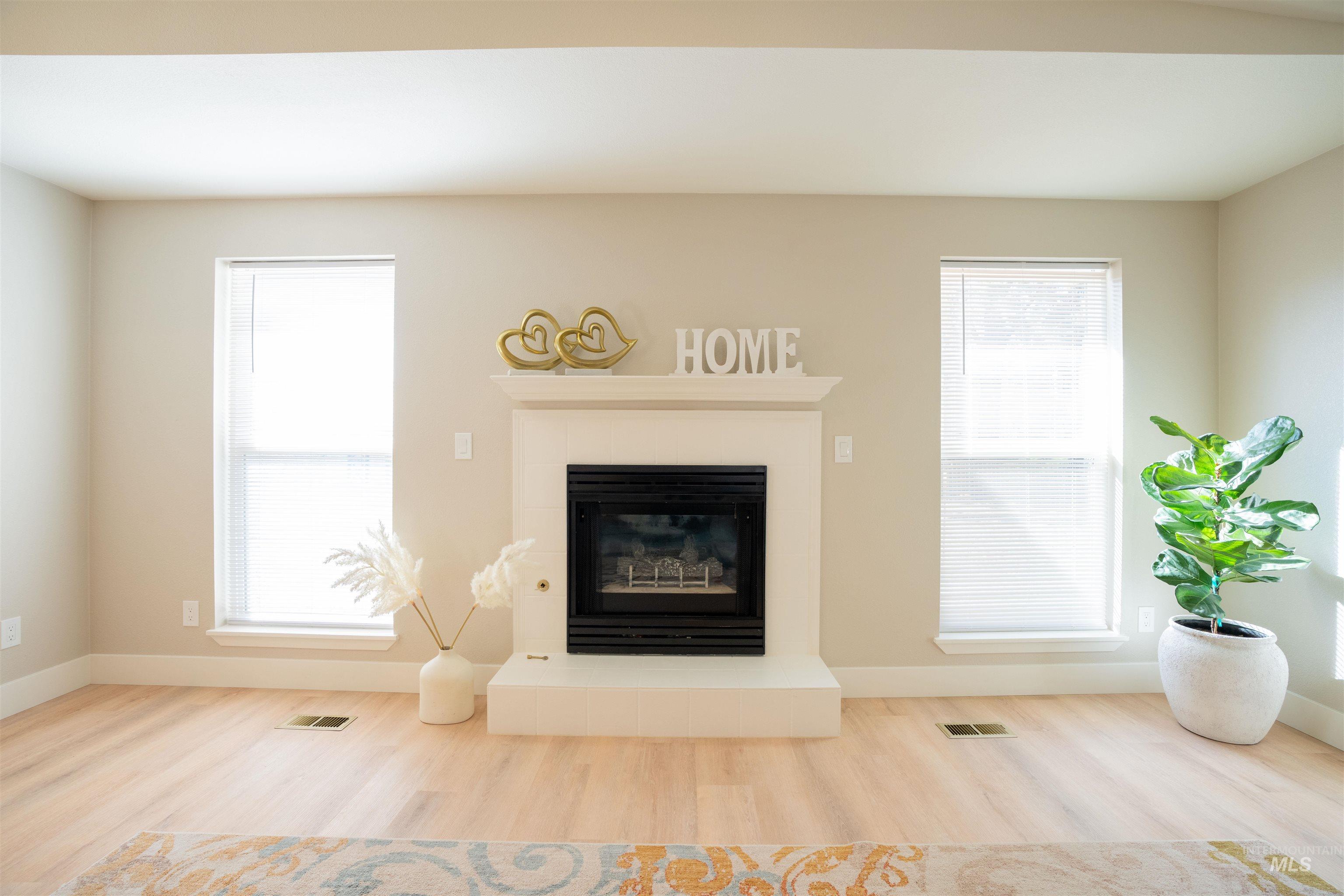 4667 Shawnee Way Boise, ID 83709 - Photo 8 of 24 Living area featuring a tile fireplace and wood finished floors