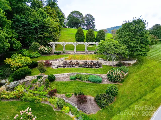 a view of a garden with a building in the background