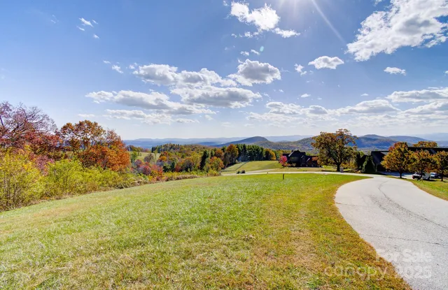 a view of a house with swimming pool and mountains in the background