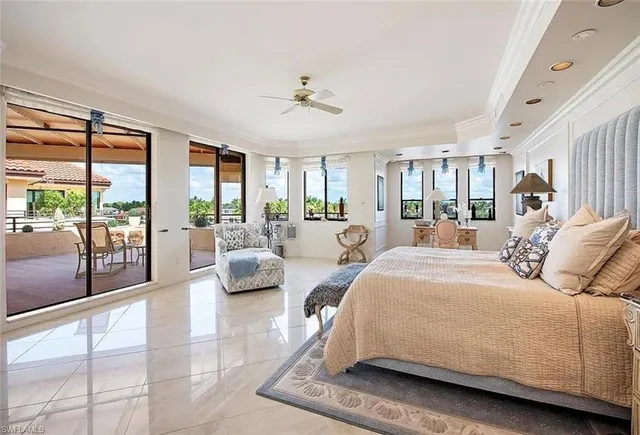 a spacious bedroom with a balcony a large bed and a large window