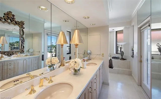 a bathroom with a sink a large mirror and a shower