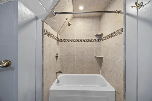 a bathroom with a bathtub and a shower