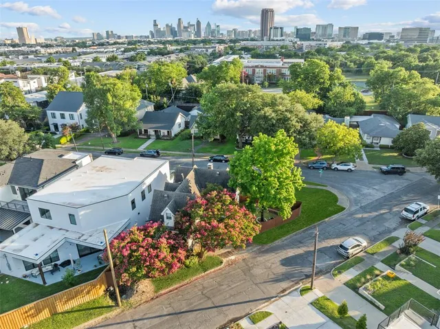an aerial view of a house with a yard basket ball court and outdoor seating