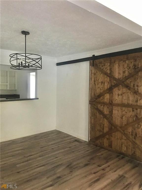 116 Edwards Street Bremen, GA 30110 - Photo 15 of 33 a view of a room with wooden floor and chandelier